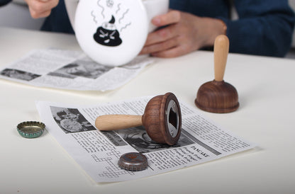 A bottle opener in the shape of a wooden toilet plug