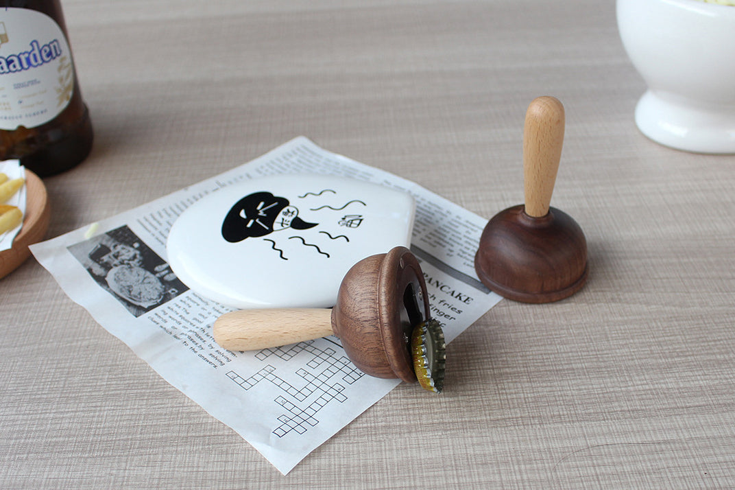 A bottle opener in the shape of a wooden toilet plug