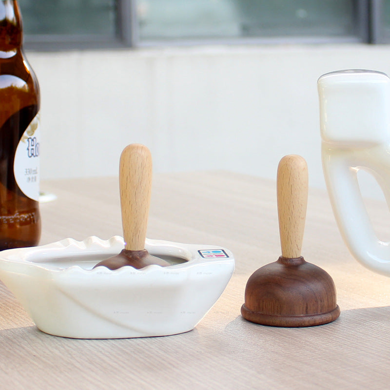 A bottle opener in the shape of a wooden toilet plug